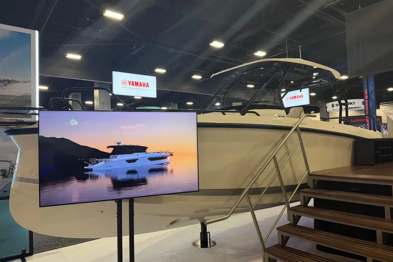 Slide: The Image of 2027 Navan T30 boat displayed at an indoor exhibition with Yamaha signage. - 4