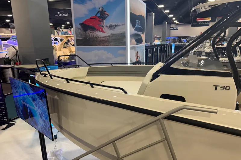Slide: The Image of 2027 Navan T30 boat displayed at a marine exhibition, showcasing sleek design and modern features. - 5