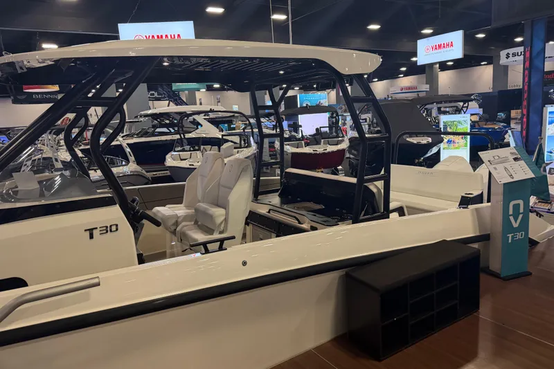 Slide: The Image of Navan T30 boat displayed at a showroom, featuring sleek design and modern seating. - 6