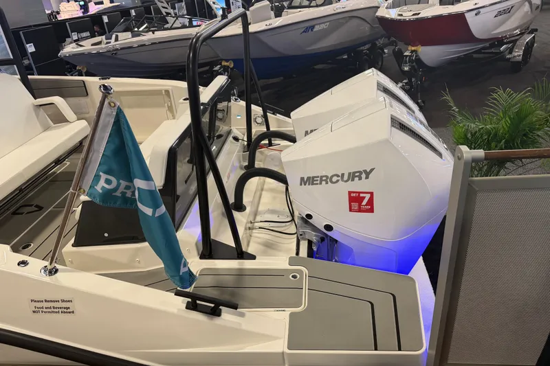 Slide: The Image of 2027 Navan T30 boat with dual Mercury engines displayed at a boat show. - 7