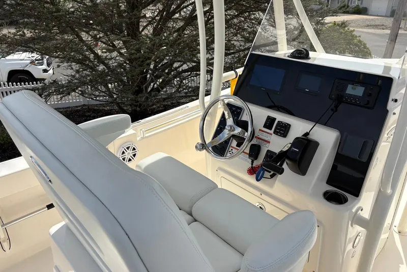 Slide: The Image of 2022 Cobia 220 Center Console boat interior with steering wheel and control panel. - 10
