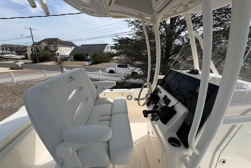 Slide: The Image of 2022 Cobia 220 Center Console boat interior with steering wheel and controls. - 11