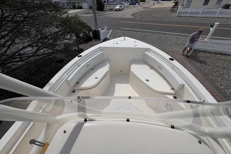 Slide: The Image of 2022 Cobia 220 Center Console boat docked near a residential area. - 14