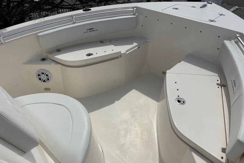 Slide: The Image of 2022 Cobia 220 Center Console boat interior with cushioned seating and storage compartments. - 15
