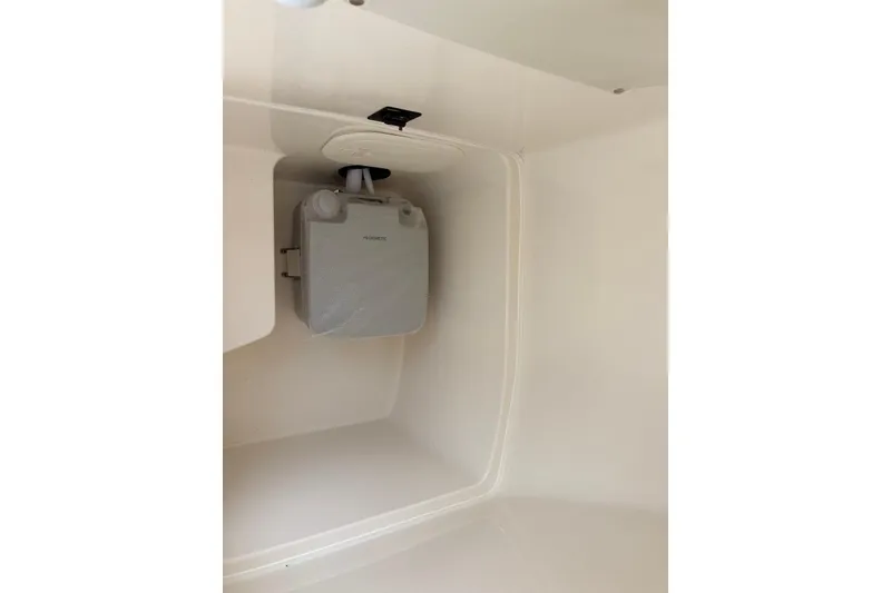Slide: The Image of Interior view of 2022 Cobia 220 Center Console boat compartment with mounted equipment. - 17