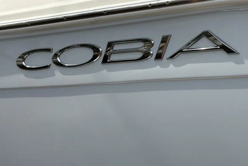 Slide: The Image of 2022 Cobia 220 Center Console boat logo in chrome lettering. - 21