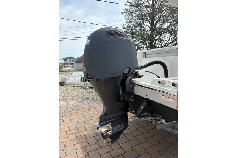 Slide: The Image of 2022 Cobia 220 Center Console boat with covered outboard motor. - 4
