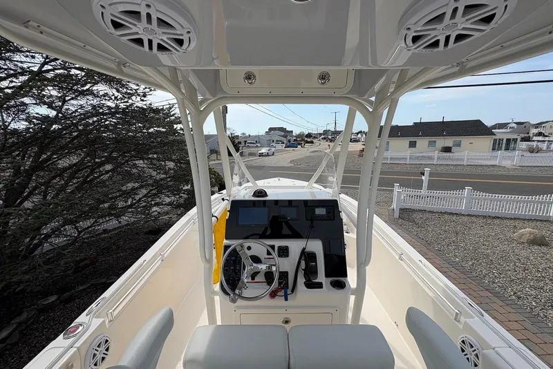 Slide: The Image of 2022 Cobia 220 Center Console boat interior with steering wheel and control panel. - 7