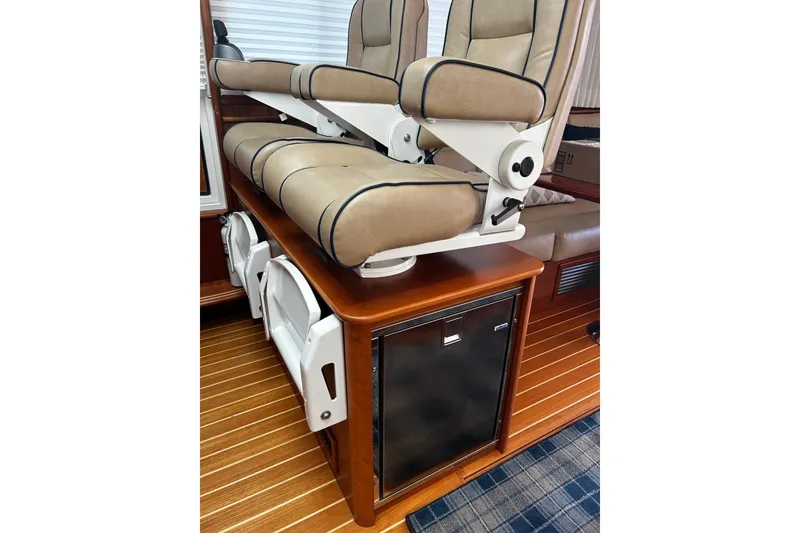 Slide: The Image of Captain's chairs on 2021 Sabre 45 Salon Express yacht, featuring elegant wood and leather design. - 13