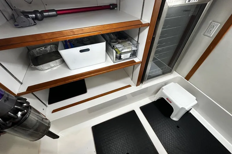 Slide: The Image of Modern galley kitchen in 2021 Sabre 45 Salon Express yacht with wood cabinetry and appliances. - 15