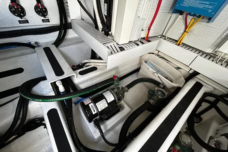 Slide: The Image of Engine room of a 2021 Sabre 45 Salon Express with visible wiring and components. - 19