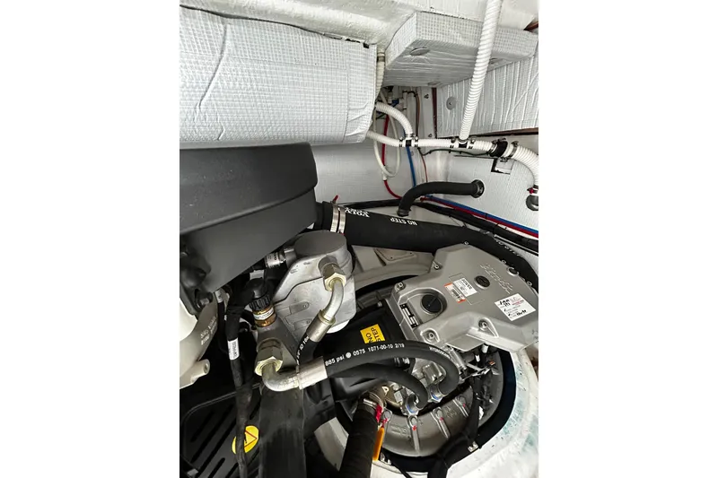 Slide: The Image of Engine compartment of 2021 Sabre 45 Salon Express yacht, showcasing mechanical components. - 22