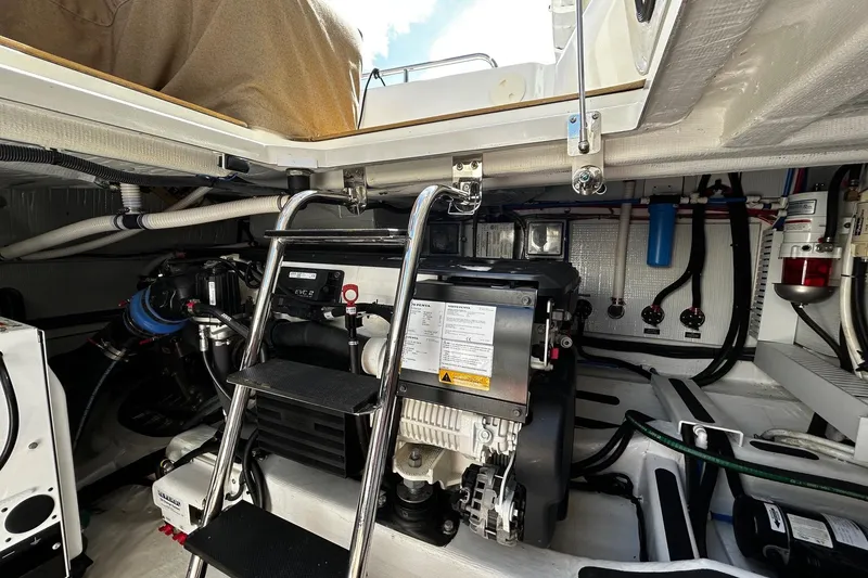 Slide: The Image of Engine room of 2021 Sabre 45 Salon Express yacht, featuring mechanical components and ladder. - 28
