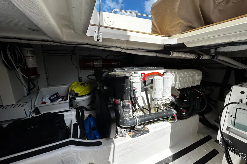 Slide: The Image of Engine room of a 2021 Sabre 45 Salon Express yacht, showcasing mechanical components and storage. - 29