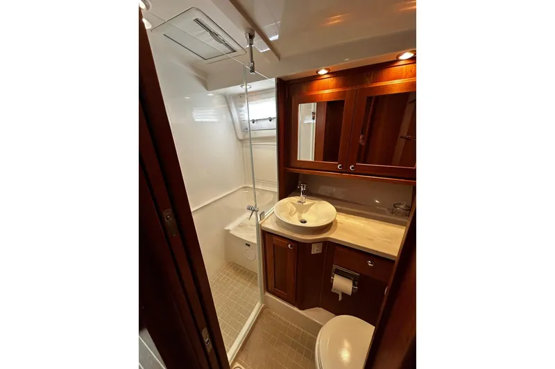 Slide: The Image of Luxurious bathroom in 2021 Sabre 45 Salon Express yacht, featuring elegant wood cabinetry and modern fixtures. - 3