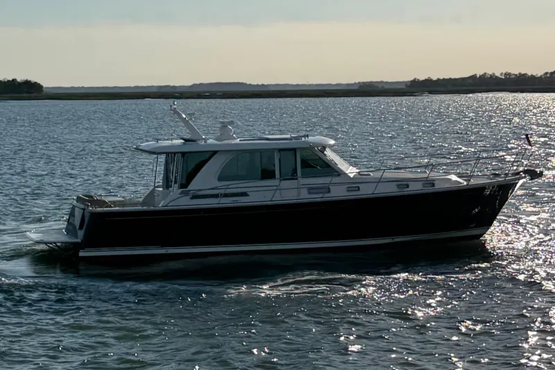 Slide: The Image of 2021 Sabre 45 Salon Express cruising on a sunlit waterway. - 35