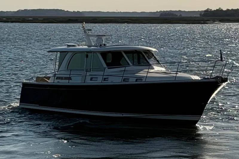 Slide: The Image of 2021 Sabre 45 Salon Express yacht cruising on open water at sunset. - 40