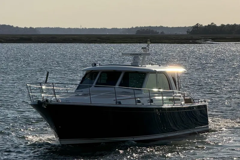 Slide: The Image of 2021 Sabre 45 Salon Express cruising on a sunlit waterway. - 41