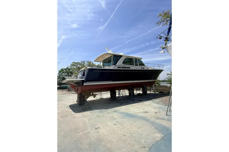 Slide: The Image of 2021 Sabre 45 Salon Express yacht on dry dock under clear blue sky. - 44
