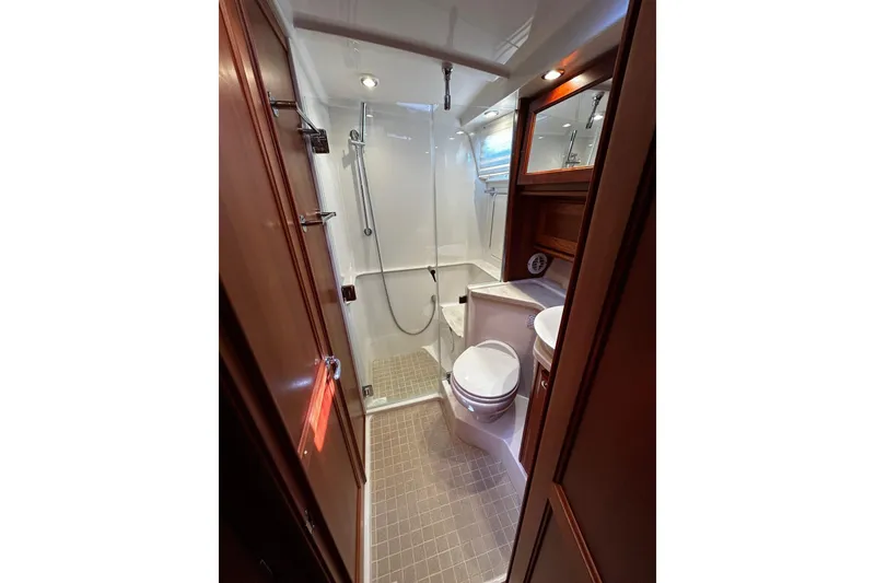 Slide: The Image of Luxurious bathroom in 2021 Sabre 45 Salon Express yacht, featuring modern fixtures and elegant wood finishes. - 5