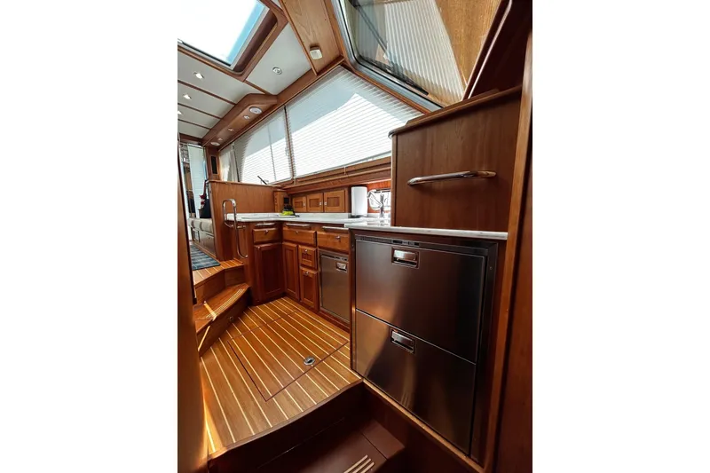 Slide: The Image of Interior of 2021 Sabre 45 Salon Express yacht, featuring elegant wood cabinetry and modern appliances. - 6