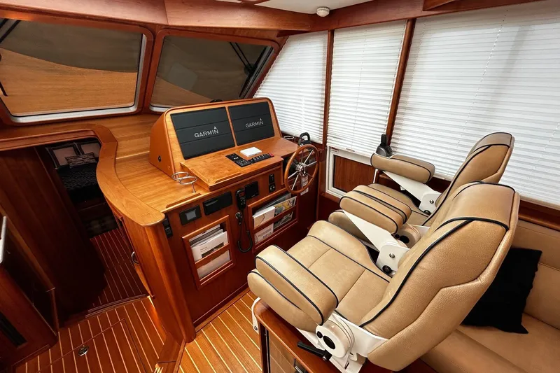 Slide: The Image of Interior of 2021 Sabre 45 Salon Express yacht with helm, dual seats, and Garmin displays. - 9