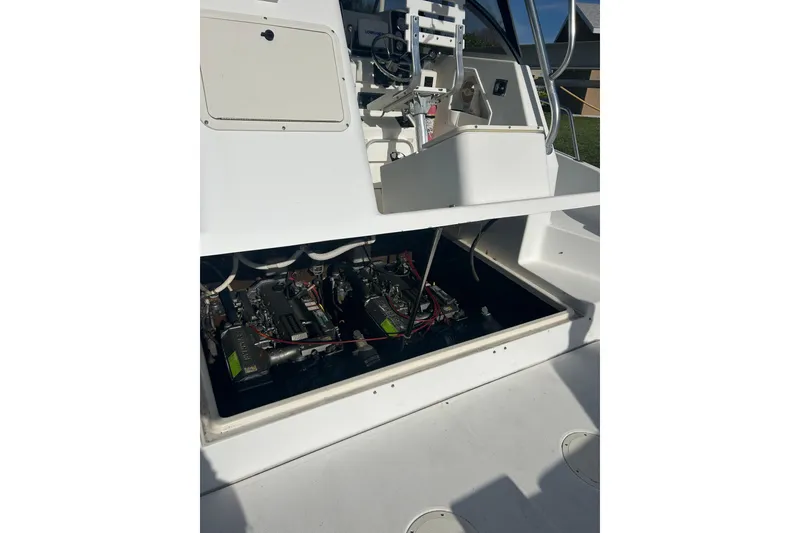 Slide: The Image of 2000 Shamrock 290 Walkaround boat engine compartment with visible machinery and wiring. - 10