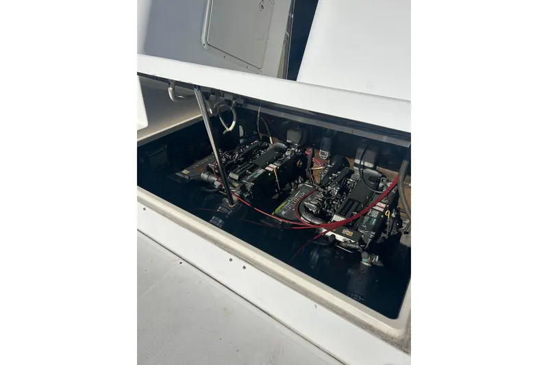 Slide: The Image of Engine compartment of a 2000 Shamrock 290 Walkaround boat, showcasing dual engines. - 11