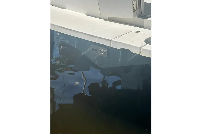 Slide: The Image of 2000 Shamrock 290 Walkaround boat hull partially submerged in water. - 13