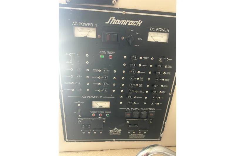 Slide: The Image of Electrical control panel of a 2000 Shamrock 290 Walkaround boat, showing AC and DC power switches. - 17