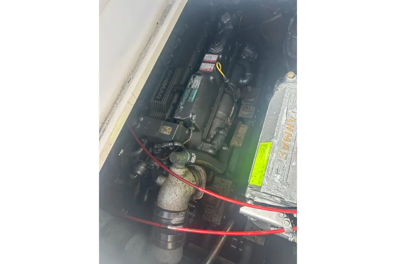 Slide: The Image of Engine compartment of a 2000 Shamrock 290 Walkaround boat, featuring a Yanmar engine. - 23
