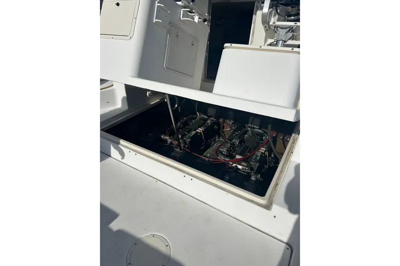 Slide: The Image of Engine compartment of a 2000 Shamrock 290 Walkaround boat, showcasing internal components. - 7