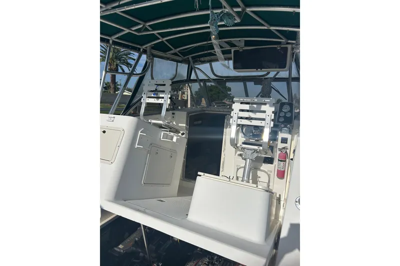 Slide: The Image of 2000 Shamrock 290 Walkaround boat interior with helm and seating area. - 8