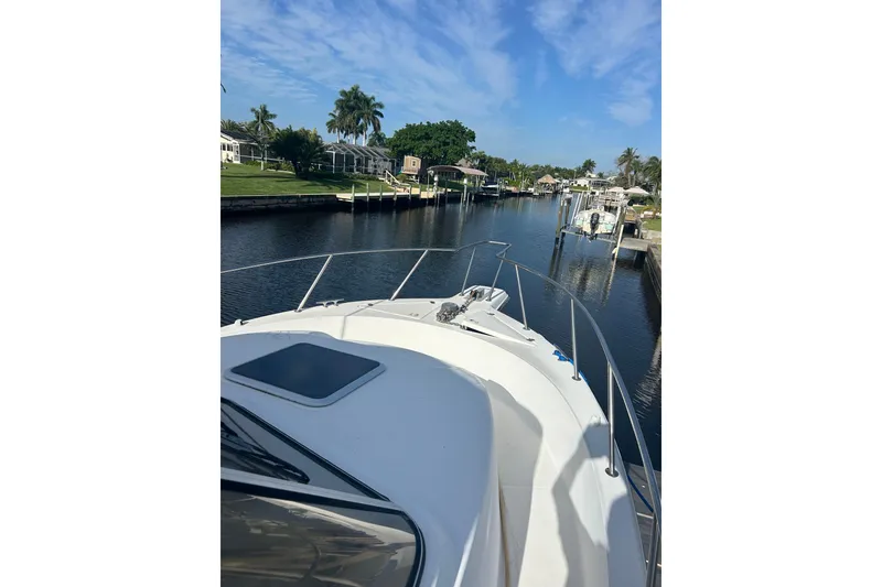 Slide: The Image of Bow view of 2000 Shamrock 290 Walkaround boat on a serene canal. - 9