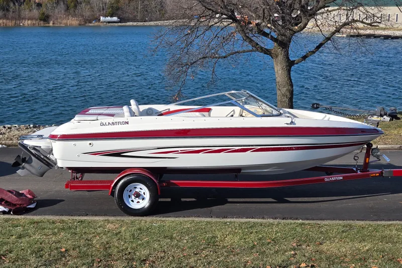 The Image of 2007 Glastron GT 205 Ski & Fish boat on trailer by a lake. - 0