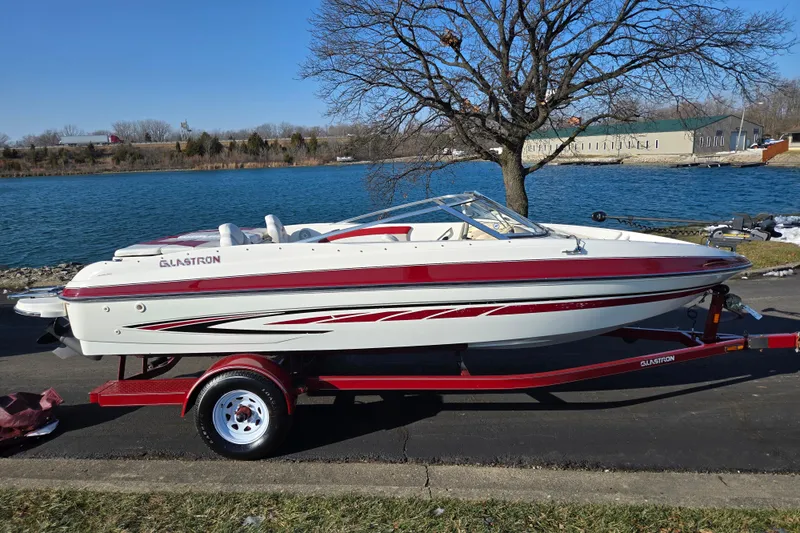 Slide: The Image of 2007 Glastron GT 205 Ski & Fish boat on trailer by a lake. - 10