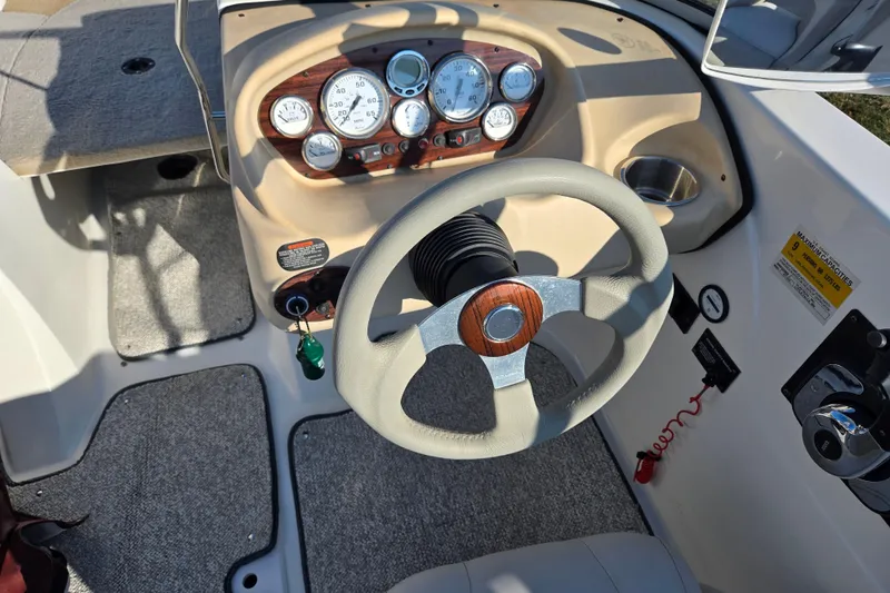 Slide: The Image of 2007 Glastron GT 205 Ski & Fish boat dashboard with steering wheel and instrument panel. - 13