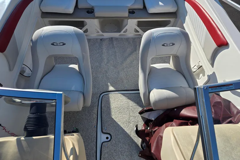 Slide: The Image of 2007 Glastron GT 205 Ski & Fish boat interior with white seats and red accents. - 21