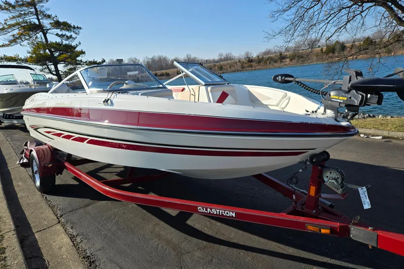 Slide: The Image of 2007 Glastron GT 205 Ski & Fish boat on trailer by a lake. - 9