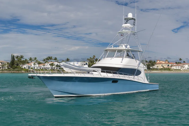 Slide: The Image of 2015 Hatteras GT70 yacht cruising near luxury waterfront homes. - 11