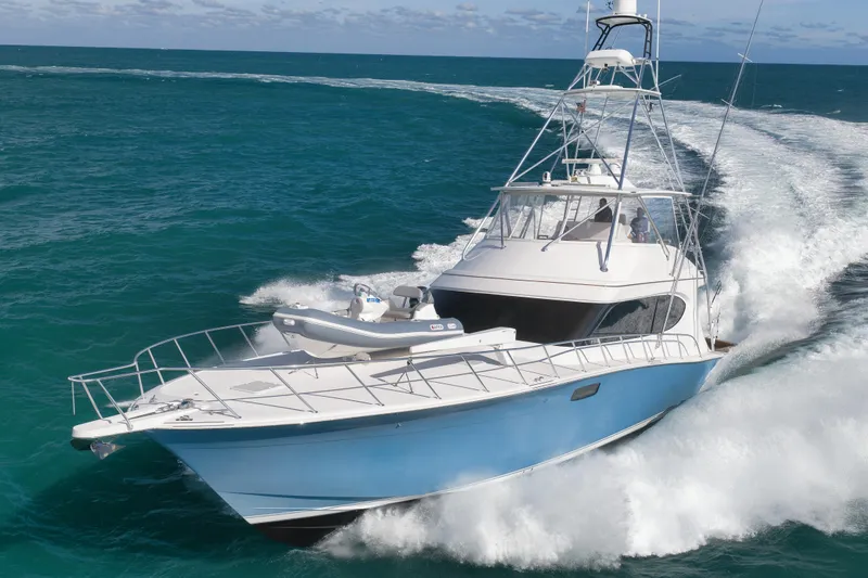 Slide: The Image of 2015 Hatteras GT70 yacht cruising on open ocean waters. - 2