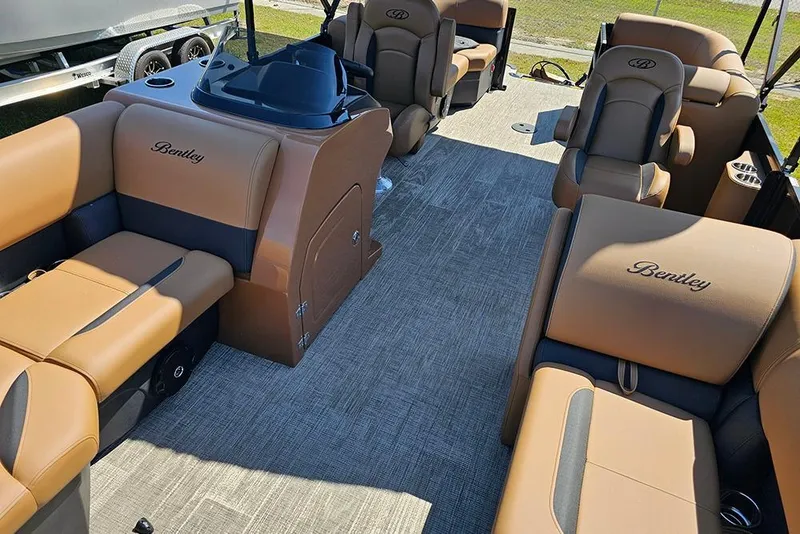 Slide: The Image of 2026 Bentley Pontoons Legacy 200 Navigator interior with luxurious tan seating and modern design. - 10