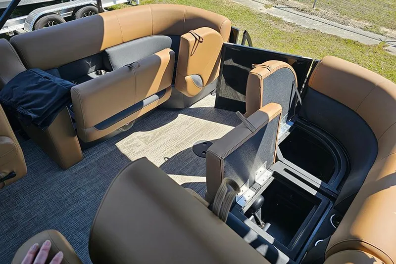 Slide: The Image of Interior of 2026 Bentley Pontoons Legacy 200 Navigator with tan seating and storage compartments. - 12