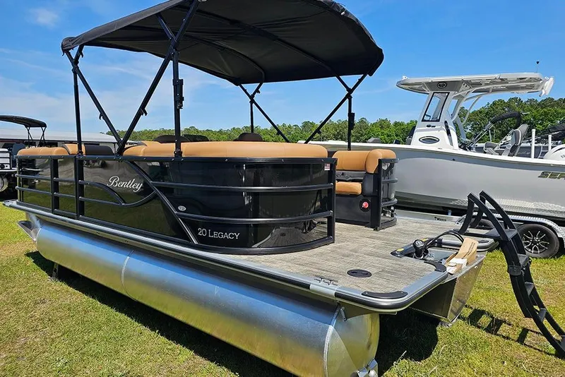 Slide: The Image of 2026 Bentley Pontoons Legacy 200 Navigator on grass, showcasing sleek design and spacious deck. - 7