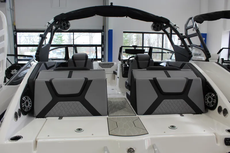 Slide: The Image of 2026 Yamaha Boats 222XD interior with modern seating and sleek design in showroom. - 2