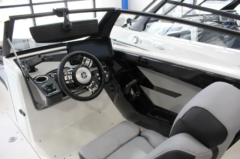 Slide: The Image of Interior view of 2026 Yamaha Boats 222XD, featuring modern steering and dashboard controls. - 4