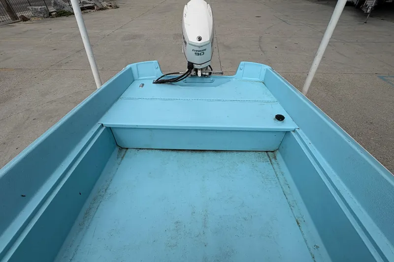 Slide: The Image of 1963 Boston Whaler 16 boat interior with Evinrude motor, light blue finish. - 14