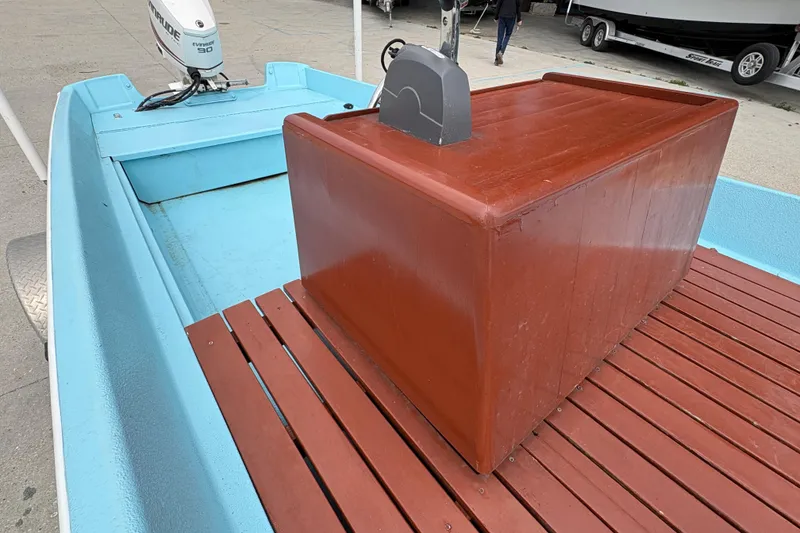 Slide: The Image of 1963 Boston Whaler 16 boat with Evinrude motor, featuring blue and brown interior. - 17