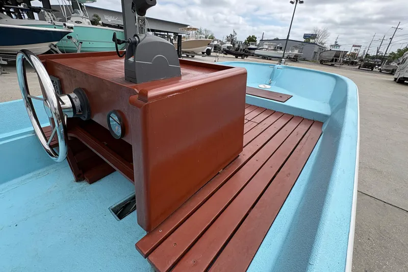 Slide: The Image of 1963 Boston Whaler 16 boat interior with wooden console and blue deck. - 18
