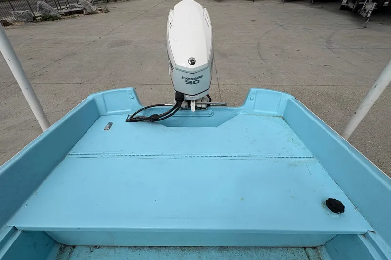 Slide: The Image of 1963 Boston Whaler 16 boat with Evinrude 90 outboard motor, light blue interior. - 20